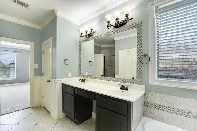 468 Monahans Dr, Georgetown, TX 78628 - bathroom with tile patterned floors, ornamental molding, a garden tub, double vanity, and a stall shower