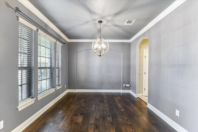 468 Monahans Dr, Georgetown, TX 78628 - empty room with arched walkways, hardwood / wood-style flooring, crown molding, and a chandelier