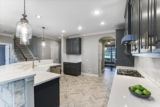 468 Monahans Dr, Georgetown, TX 78628 - kitchen with arched walkways, stainless steel appliances, tasteful backsplash, crown molding, and recessed lighting