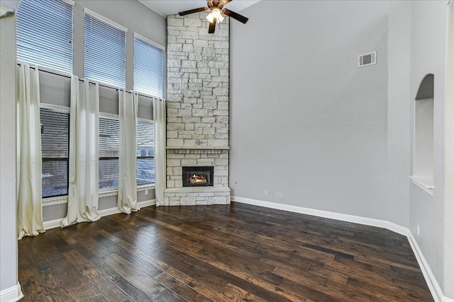 468 Monahans Dr, Georgetown, TX 78628 - unfurnished living room featuring ceiling fan, wood finished floors, and a stone fireplace