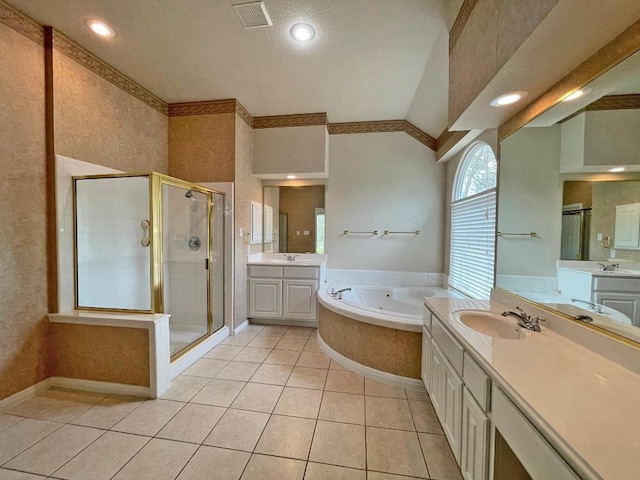 bathroom with a shower stall, a bath, tile patterned floors, two vanities, and recessed lighting