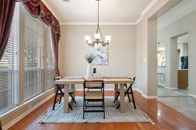 1502 Azalea Dr, Cedar Park, TX 78613 - dining space featuring a chandelier, wood finished floors, crown molding, and baseboards