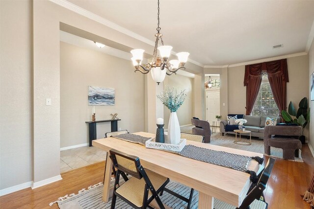 1502 Azalea Dr, Cedar Park, TX 78613 - dining room featuring a chandelier, light wood-style flooring, ornamental molding, and baseboards