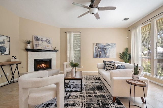 1502 Azalea Dr, Cedar Park, TX 78613 - living area with a brick fireplace, tile patterned flooring, ceiling fan, and baseboards