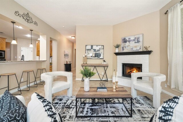 1502 Azalea Dr, Cedar Park, TX 78613 - living area with a brick fireplace, baseboards, and light tile patterned flooring