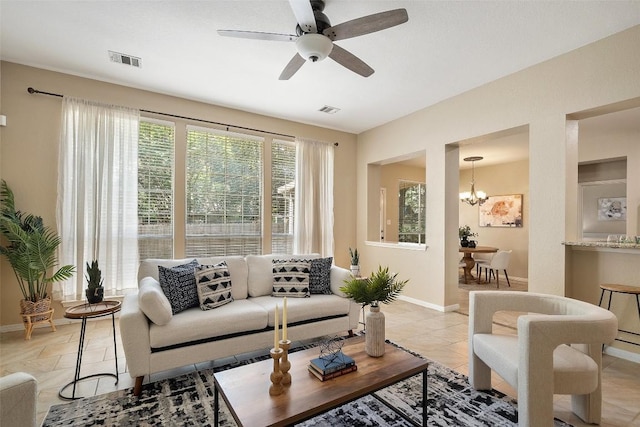 1502 Azalea Dr, Cedar Park, TX 78613 - living area featuring a chandelier, baseboards, ceiling fan, and light tile patterned floors