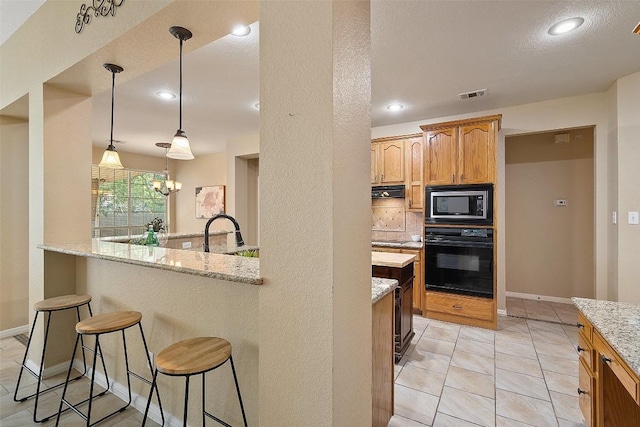 1502 Azalea Dr, Cedar Park, TX 78613 - kitchen with oven, built in microwave, a kitchen bar, decorative backsplash, and light stone counters