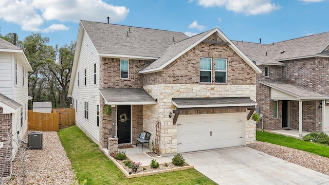 2024 Cantonata Dr, Leander, TX 78641 - view of front facade with a garage, concrete driveway, a shingled roof, stone siding, and brick siding