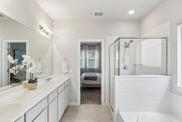 2024 Cantonata Dr, Leander, TX 78641 - ensuite bathroom with double vanity, a shower stall, tile patterned flooring, a garden tub, and recessed lighting