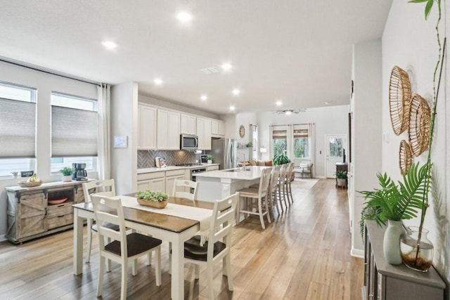 2024 Cantonata Dr, Leander, TX 78641 - dining space featuring light wood-style flooring and recessed lighting