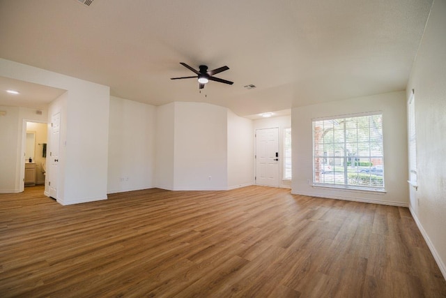 1420 Marsh Harbour Dr, Round Rock, TX 78664 - unfurnished living room featuring wood finished floors, baseboards, and a ceiling fan
