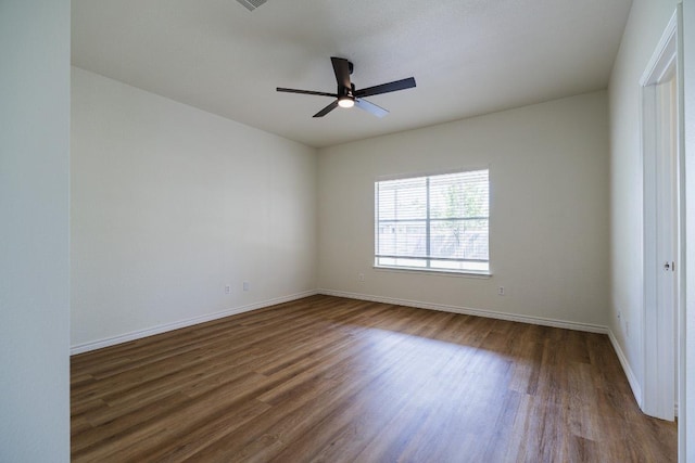 1420 Marsh Harbour Dr, Round Rock, TX 78664 - empty room with dark wood finished floors, baseboards, and a ceiling fan