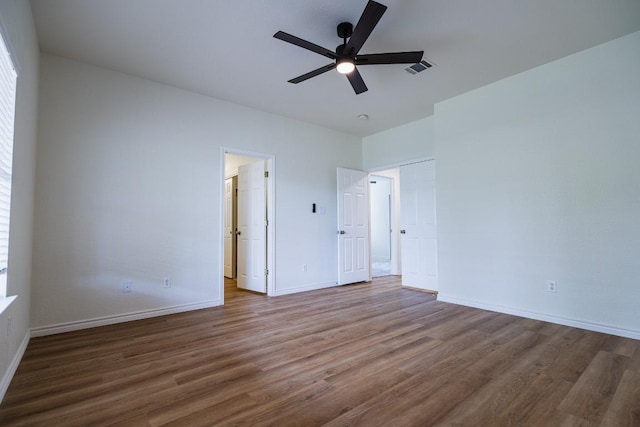 1420 Marsh Harbour Dr, Round Rock, TX 78664 - unfurnished bedroom with wood finished floors, baseboards, and ceiling fan