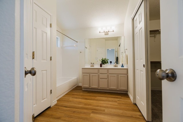1420 Marsh Harbour Dr, Round Rock, TX 78664 - bathroom with wood finished floors, bathtub / shower combination, double vanity, and a closet