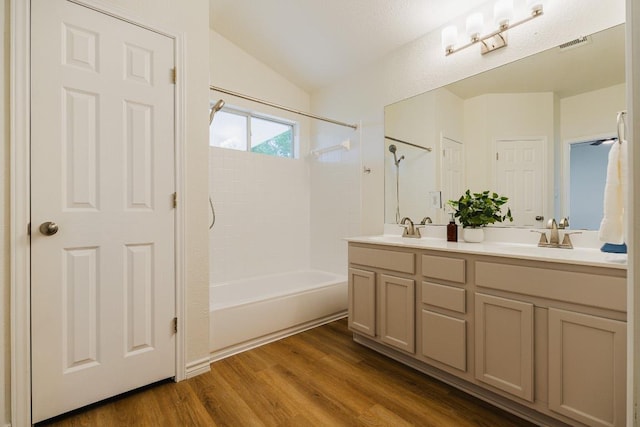1420 Marsh Harbour Dr, Round Rock, TX 78664 - bathroom with double vanity, wood finished floors, shower / washtub combination, and lofted ceiling