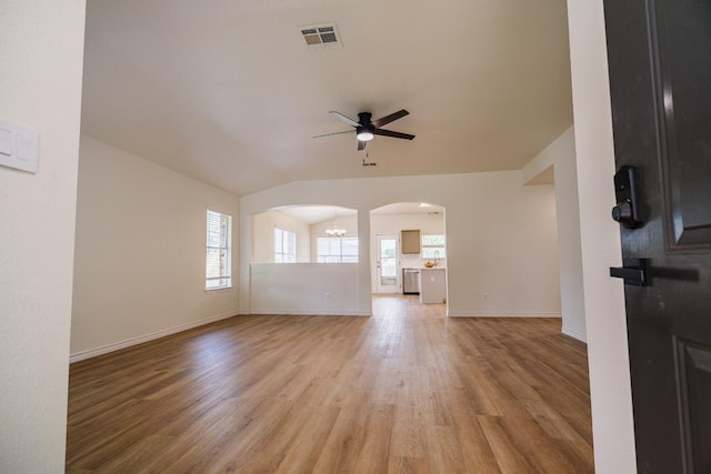 1420 Marsh Harbour Dr, Round Rock, TX 78664 - unfurnished living room with a ceiling fan, arched walkways, light wood-style floors, lofted ceiling, and baseboards