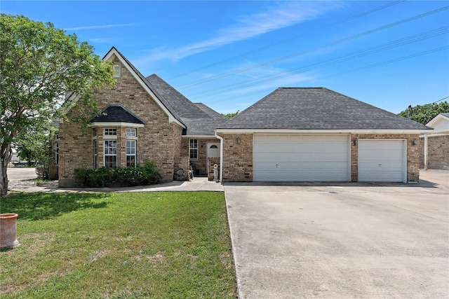 3424 S Old Bastrop Hwy, San Marcos, TX 78666 - view of front of home featuring brick siding, a front lawn, an attached garage, a shingled roof, and driveway