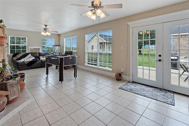 3424 S Old Bastrop Hwy, San Marcos, TX 78666 - game room featuring a ceiling fan, french doors, light tile patterned floors, baseboards, and a textured ceiling