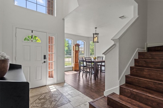 21016 Penny Royal Dr, Pflugerville, TX 78660 - foyer entrance with plenty of natural light, stone tile flooring, stairway, and a towering ceiling