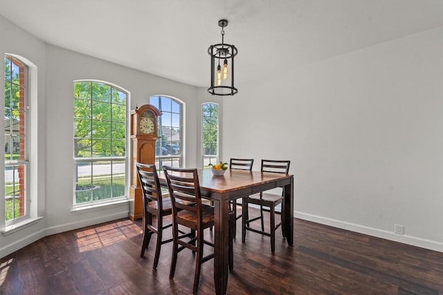 dining space with baseboards and dark wood-style flooring