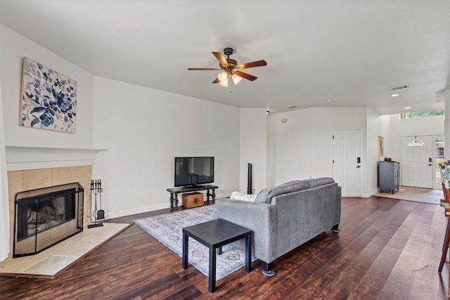 living area featuring a ceiling fan, wood finished floors, a tiled fireplace, recessed lighting, and baseboards