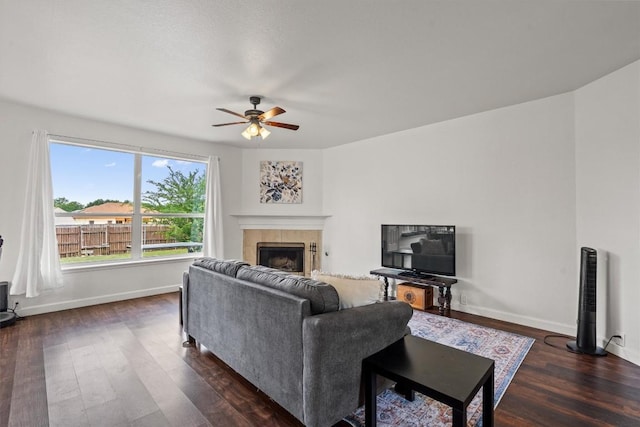 living room featuring a ceiling fan, dark wood finished floors, and baseboards