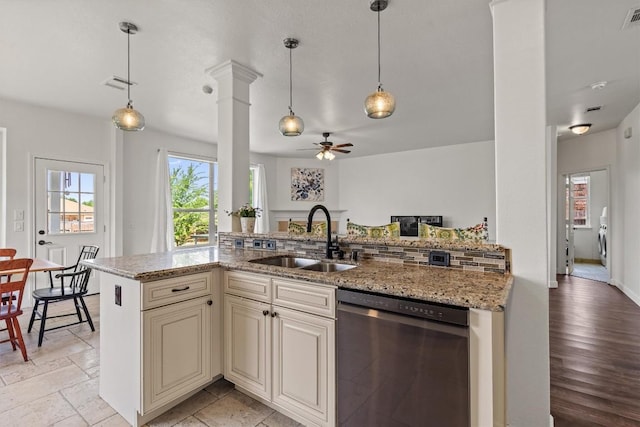 21016 Penny Royal Dr, Pflugerville, TX 78660 - kitchen featuring dishwashing machine, a sink, cream cabinets, a ceiling fan, and light stone counters