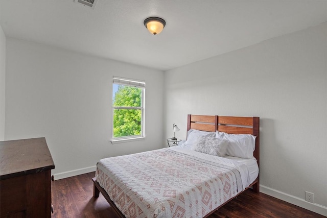 bedroom featuring baseboards and wood finished floors