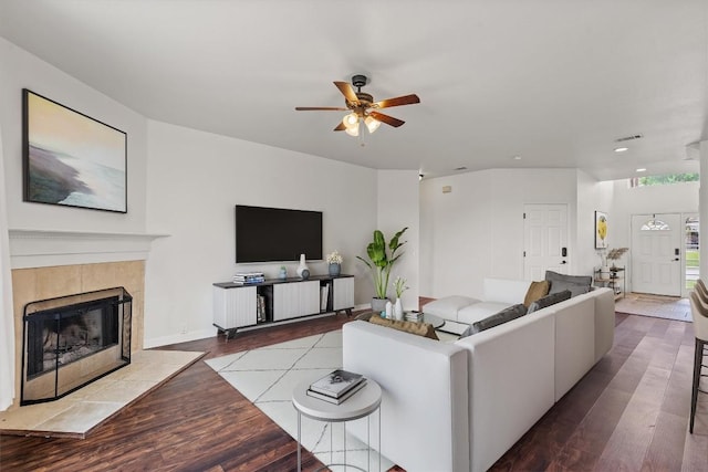 21016 Penny Royal Dr, Pflugerville, TX 78660 - living area featuring a ceiling fan, wood finished floors, a fireplace, and recessed lighting
