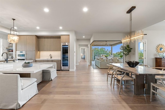 dining room with recessed lighting, light wood-style flooring, and a chandelier