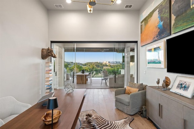 doorway to outside featuring a high ceiling and wood finished floors