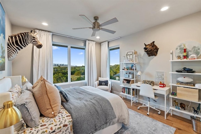 bedroom with wood finished floors, recessed lighting, a ceiling fan, and baseboards