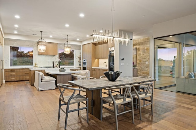 dining room featuring light wood-style flooring and recessed lighting