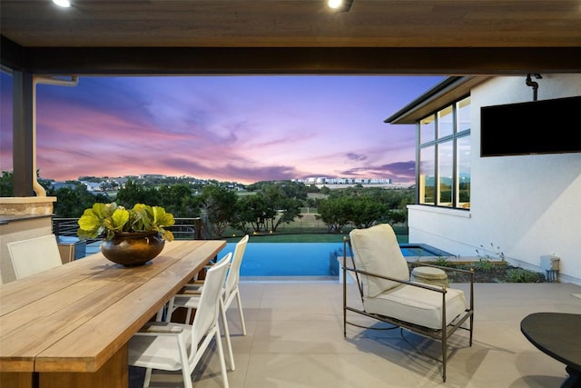 balcony featuring outdoor dining space and a patio area