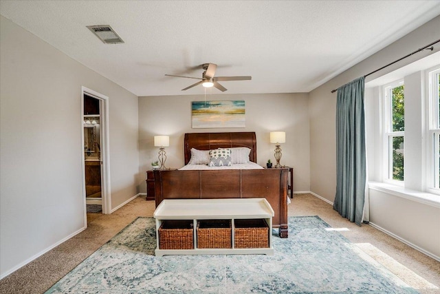 7605 Hawkeye Dr, Austin, TX 78749 - carpeted bedroom featuring baseboards, ensuite bathroom, and ceiling fan