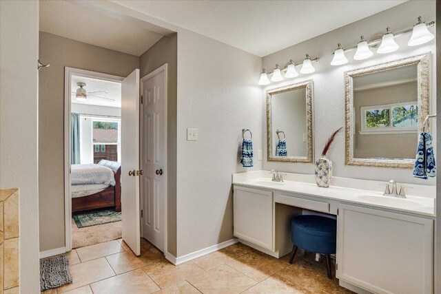 7605 Hawkeye Dr, Austin, TX 78749 - full bath featuring double vanity, baseboards, tile patterned flooring, ensuite bath, and a ceiling fan
