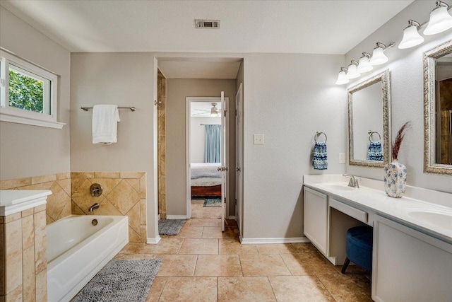7605 Hawkeye Dr, Austin, TX 78749 - ensuite bathroom with a garden tub, double vanity, baseboards, and tile patterned flooring