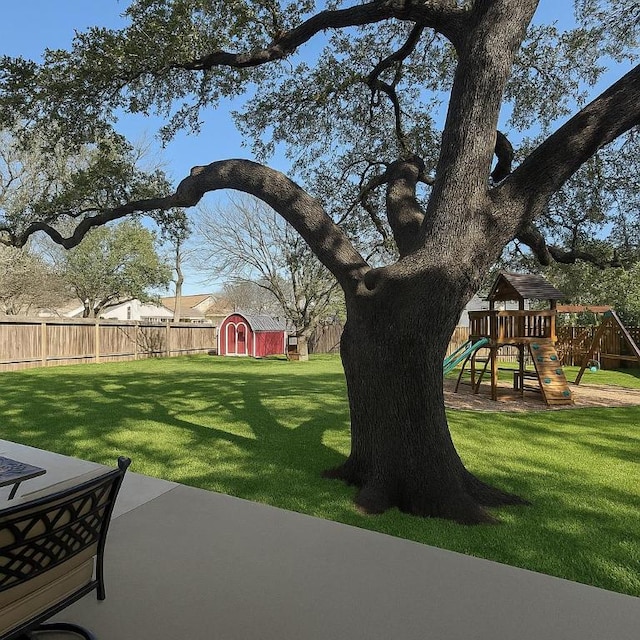 7605 Hawkeye Dr, Austin, TX 78749 - view of yard featuring a storage shed, a playground, and a patio