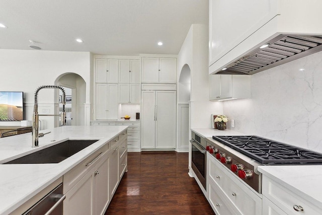 340 Palo Alto Way, Austin, TX 78732 - kitchen featuring appliances with stainless steel finishes, under cabinet range hood, arched walkways, a sink, and recessed lighting