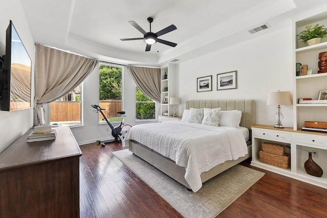 340 Palo Alto Way, Austin, TX 78732 - bedroom featuring dark wood-type flooring, a tray ceiling, and a ceiling fan