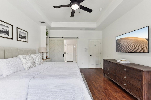 340 Palo Alto Way, Austin, TX 78732 - bedroom with a raised ceiling, dark wood finished floors, a barn door, ornamental molding, and ceiling fan