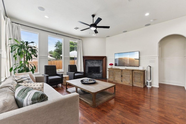 340 Palo Alto Way, Austin, TX 78732 - living area featuring wood finished floors, ceiling fan, arched walkways, a premium fireplace, and recessed lighting