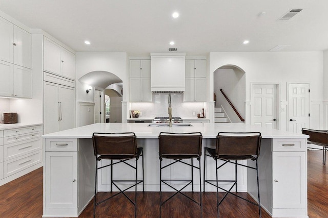 340 Palo Alto Way, Austin, TX 78732 - kitchen with custom exhaust hood, a large island, light countertops, white cabinets, and recessed lighting