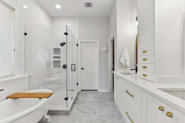 340 Palo Alto Way, Austin, TX 78732 - bathroom featuring marble look tiles, a stall shower, a freestanding tub, double vanity, and recessed lighting