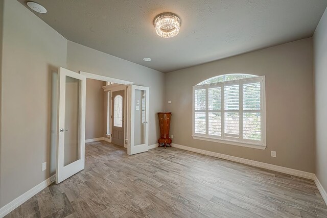 13403 Lakemeade Ct, Sugar Land, TX 77498 - entryway with french doors, wood finished floors, and baseboards