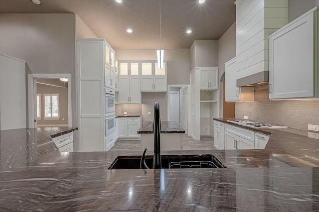 13403 Lakemeade Ct, Sugar Land, TX 77498 - kitchen featuring a sink, decorative backsplash, dark stone countertops, recessed lighting, and double oven