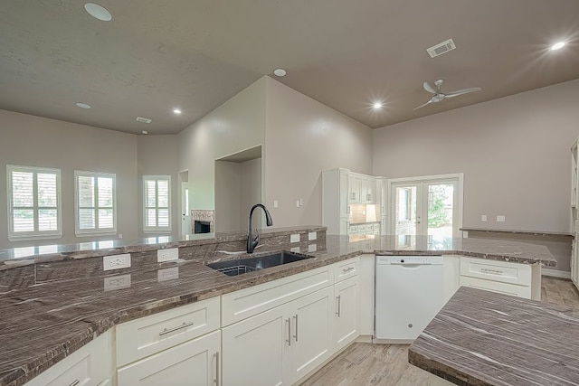 13403 Lakemeade Ct, Sugar Land, TX 77498 - kitchen with dishwasher, a sink, a ceiling fan, dark stone counters, and white cabinets