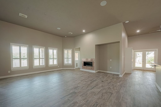 13403 Lakemeade Ct, Sugar Land, TX 77498 - unfurnished living room featuring light wood finished floors, french doors, baseboards, a fireplace, and recessed lighting