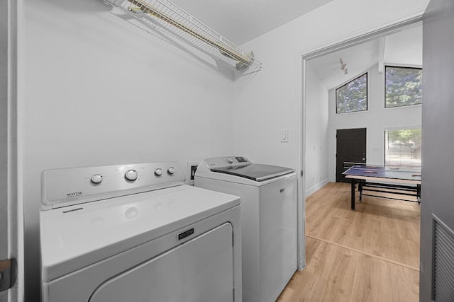 12001 Bittern Holw, Austin, TX 78758 - washroom with washer and clothes dryer and light wood-type flooring