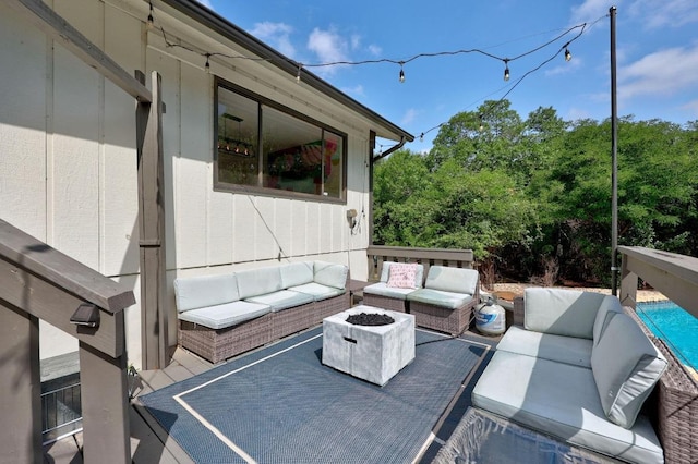 view of patio featuring an outdoor living space with a fire pit